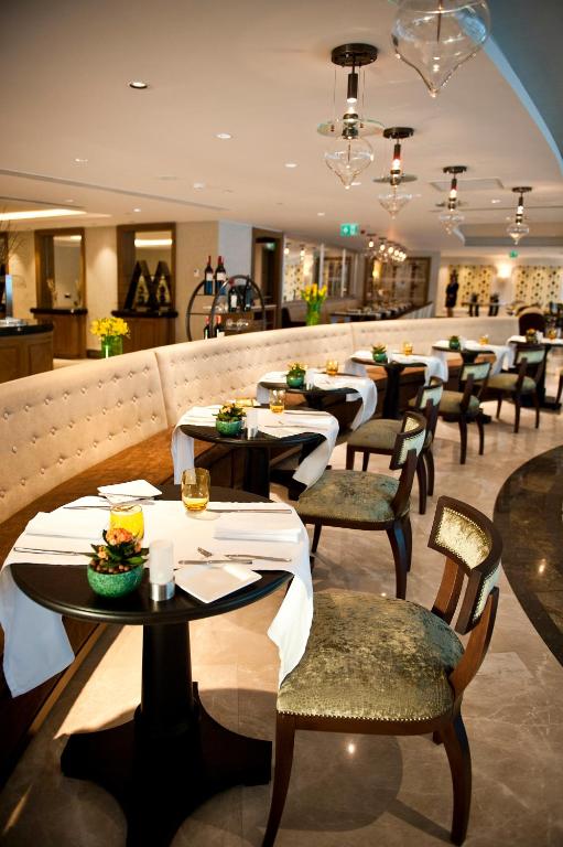 a dining room with tables and chairs in a restaurant at The Grand Tarabya Managed by Accor in Istanbul