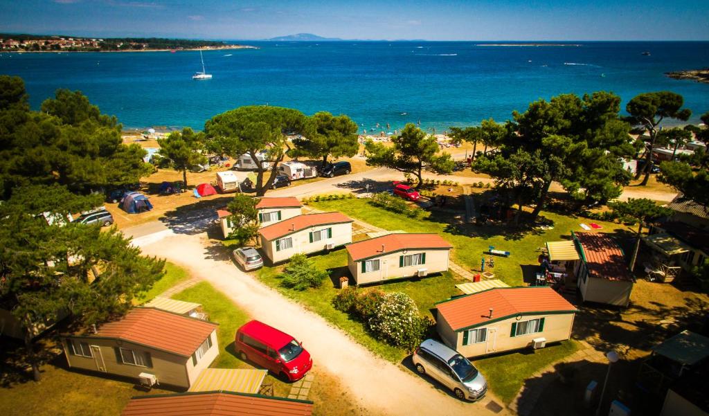 an aerial view of a small village with houses and the ocean at Arena Medulin Mobile Homes in Medulin