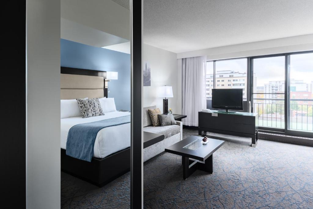 a hotel room with two beds and a large window at Ottawa Embassy Hotel & Suites in Ottawa