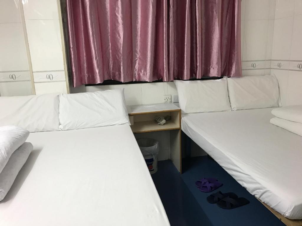 Postel nebo postele na pokoji v ubytování Beverly Guest House