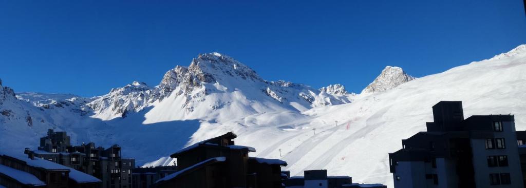 a view of a snow covered mountain with a city at Duplex à la Moutière in Tignes