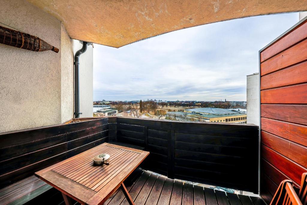 a balcony with a wooden table and a view at My Budapest Apartment in Budapest