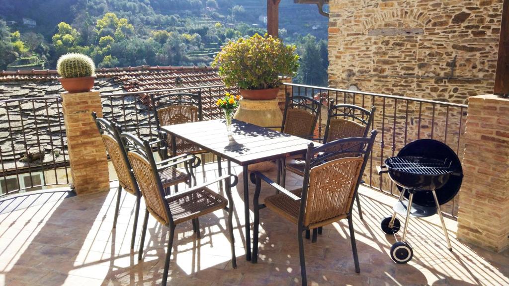 a table and chairs on a balcony with a view at Casa Pablo in Badalucco