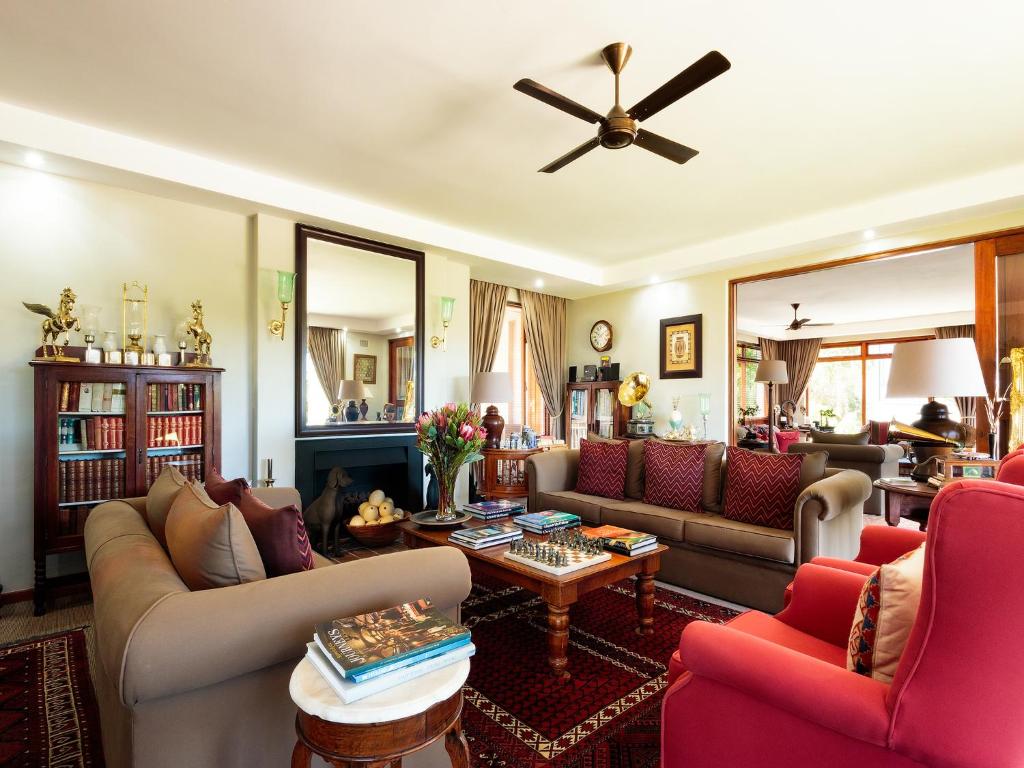 a living room with couches and a ceiling fan at Wilderness Manor in Wilderness