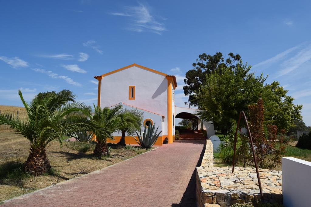 een klein wit huis met een pad dat er naartoe leidt bij Quinta da Aurora in Évora