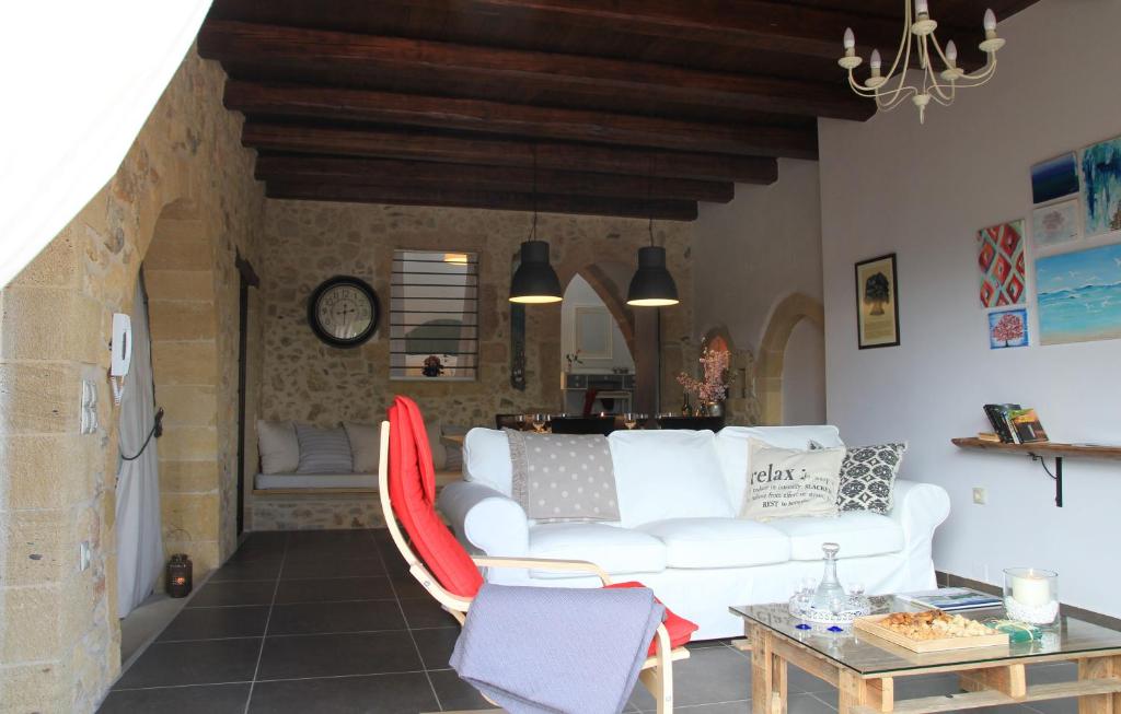 a living room with a white couch and a table at Meli-milon in Kolymvari