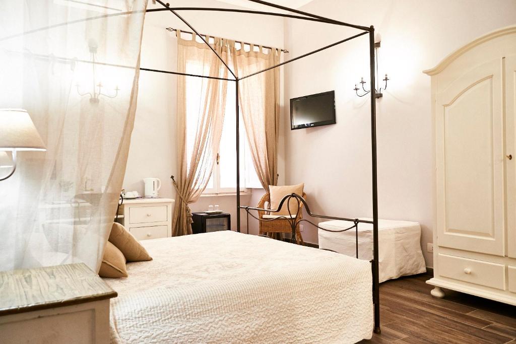 a bedroom with a canopy bed and a window at Ale & Niki's Home in Rome