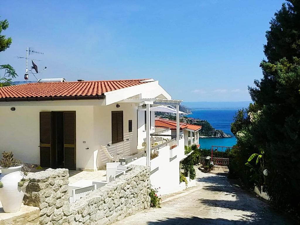 a white house with a view of the ocean at Villa Anna Maria in Capo Vaticano
