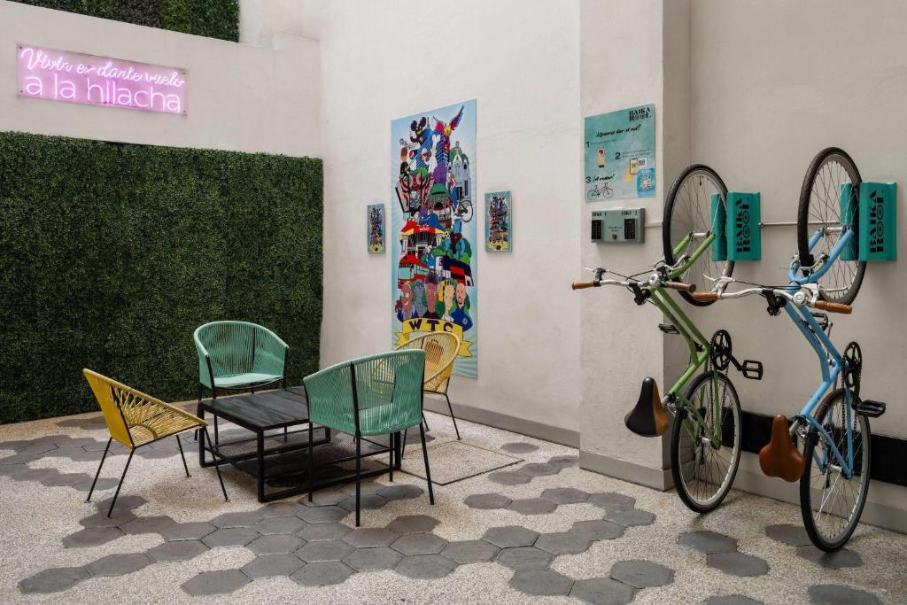A colourful communal seating area with bicycles mounted on the wall.