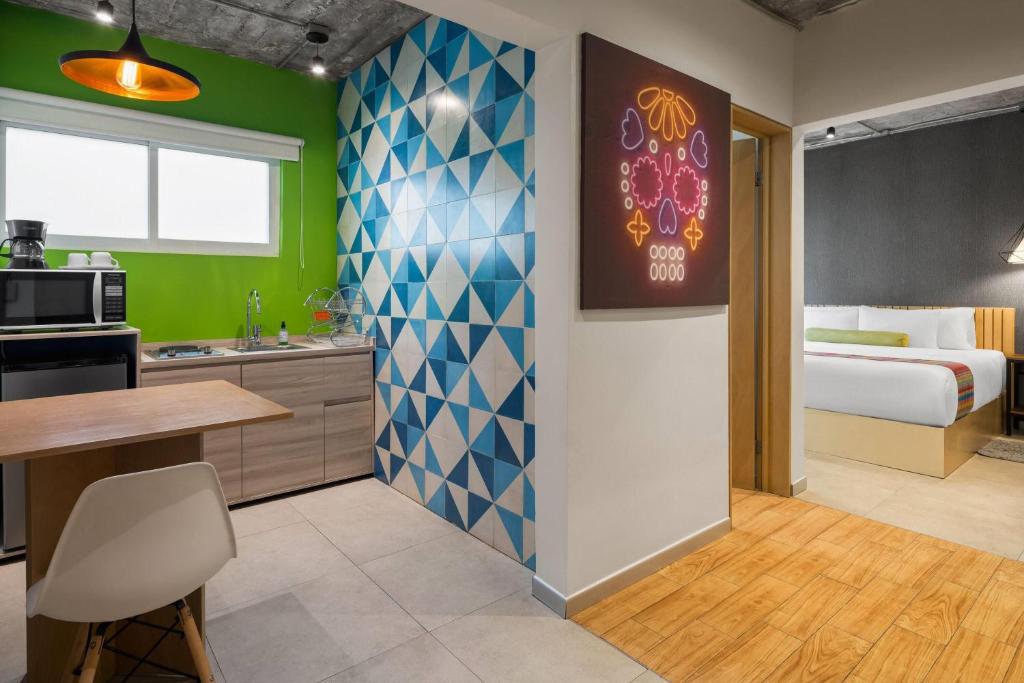 A suite view showing the kitchenette, dining area and separate two-bed sleeping area.