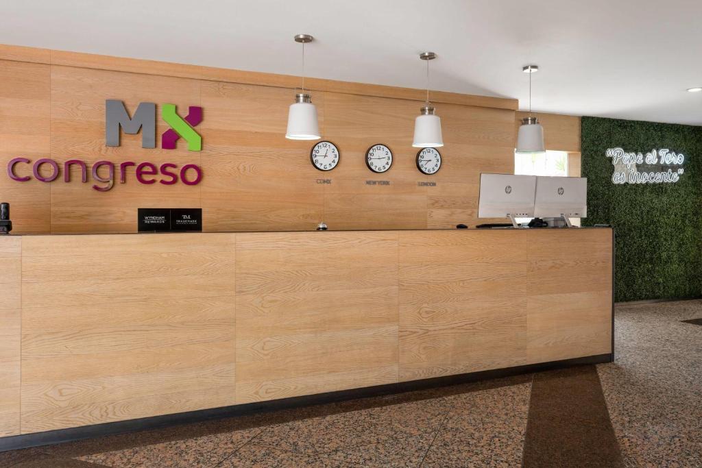 A wood-panelled reception desk with clocks showing different time zones.