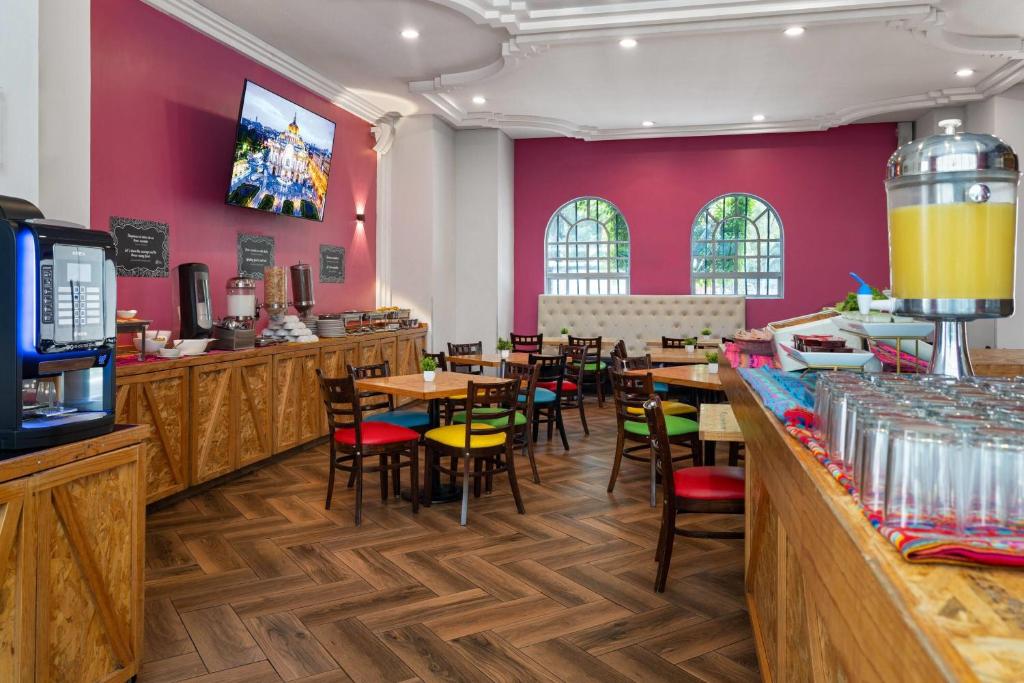A colorful breakfast room with buffet counters, drinks, and mixed seating.