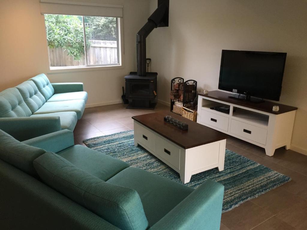 a living room with a couch and a flat screen tv at Royhaven Holiday Let in Cowes