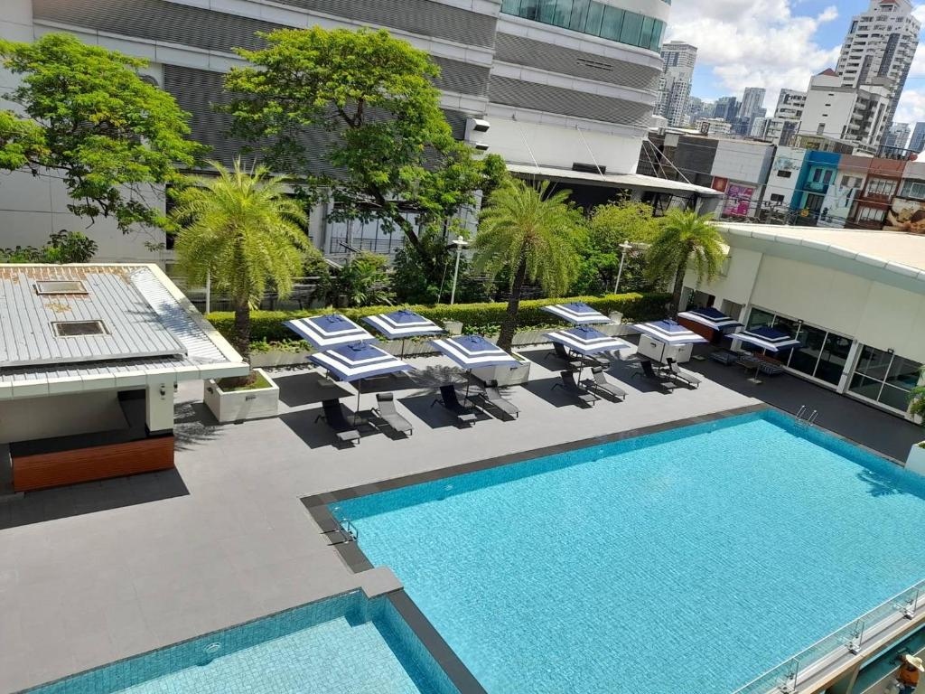 An elevated view of the pool terrace against Bangkok's urban skyline.