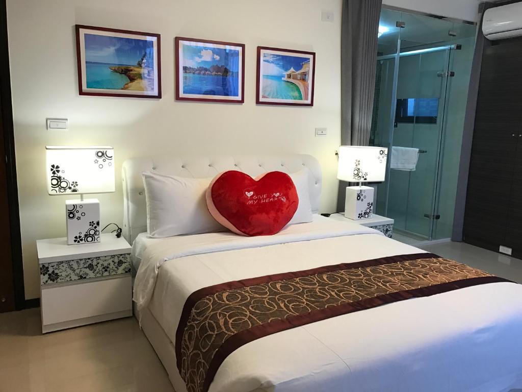 a bedroom with a red heart pillow on a bed at Grand Allevia Villa in Wujie