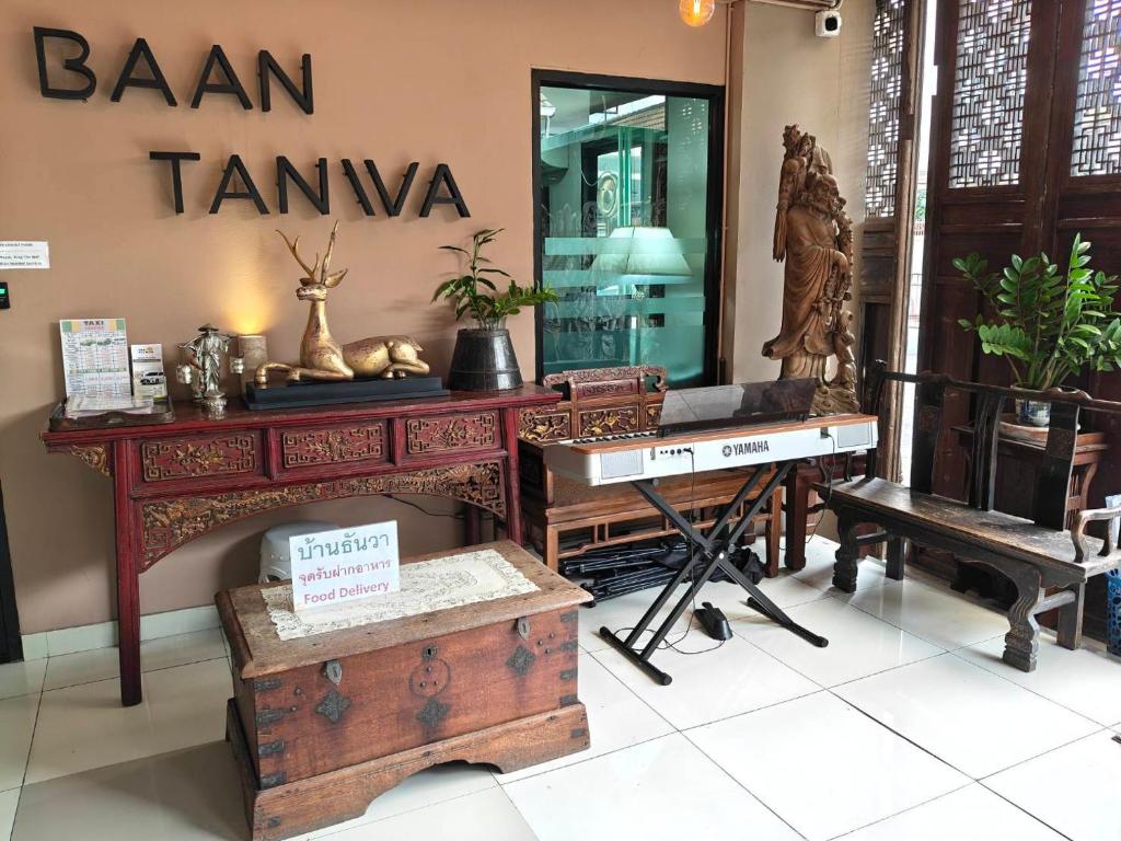 A lobby display area featuring a Yamaha keyboard and richly carved wooden furnishings.