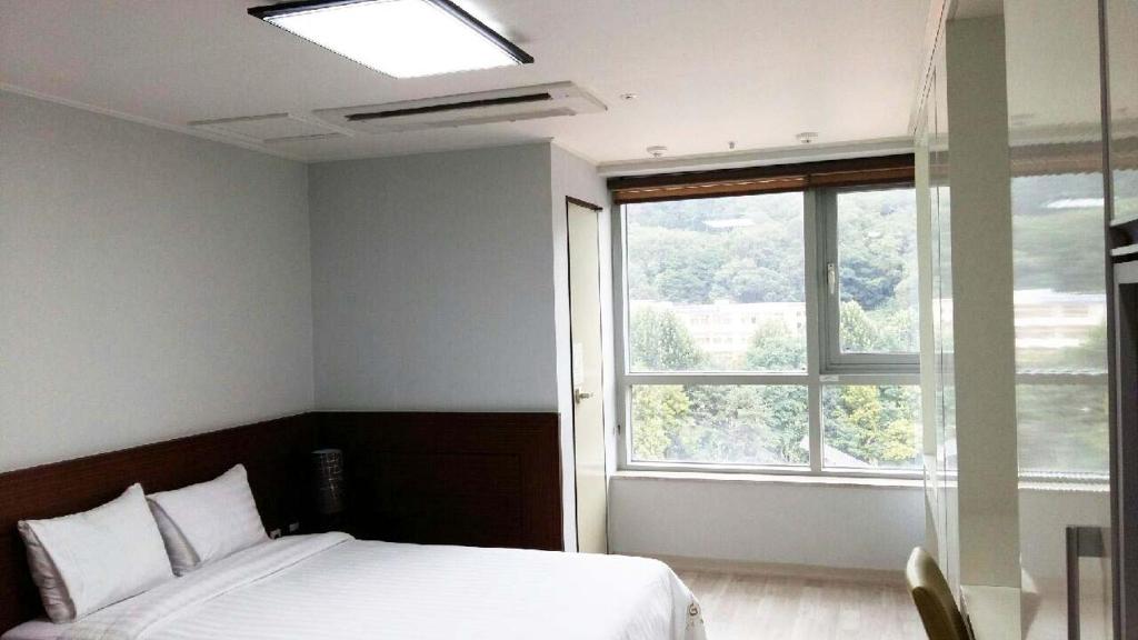 Postel nebo postele na pokoji v ubytování Gaon Residence Hotel