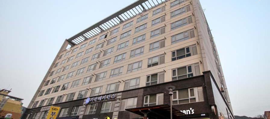 a large building on a city street with at Gaon Residence Hotel in Daejeon