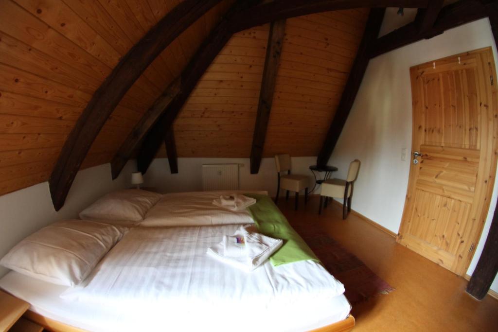 ein Schlafzimmer mit einem großen Bett im Dachgeschoss in der Unterkunft Alte Apotheke in Radebeul