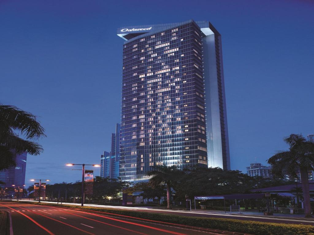 a large building with a clock on the side of it at Oakwood Premier Cozmo Jakarta in Jakarta