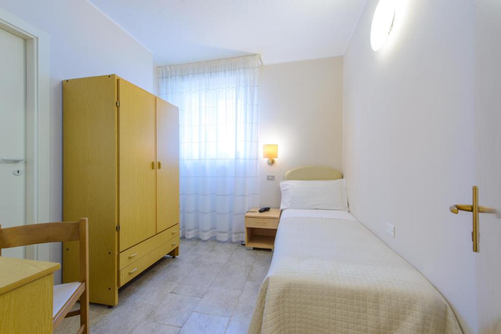 Postel nebo postele na pokoji v ubytování Hotel Falco