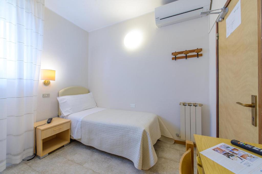 Postel nebo postele na pokoji v ubytování Hotel Falco