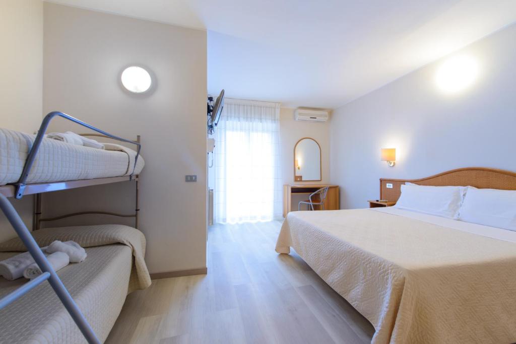 Postel nebo postele na pokoji v ubytování Hotel Falco