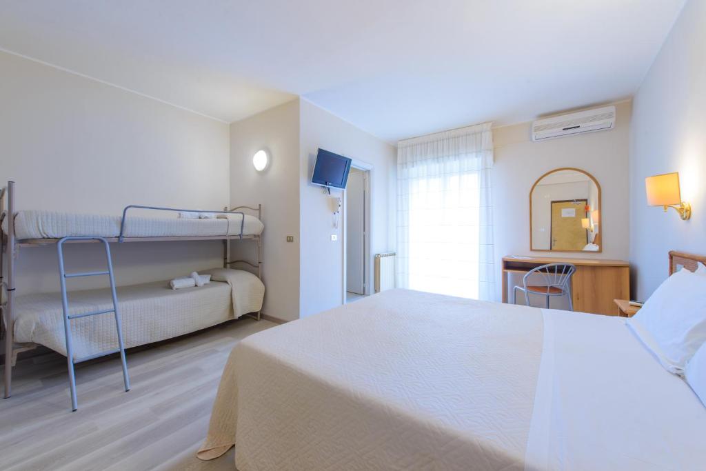 Postel nebo postele na pokoji v ubytování Hotel Falco