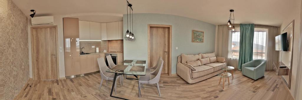 a living room with a glass table and a couch at Black Sea Royal Villa in Rogachevo