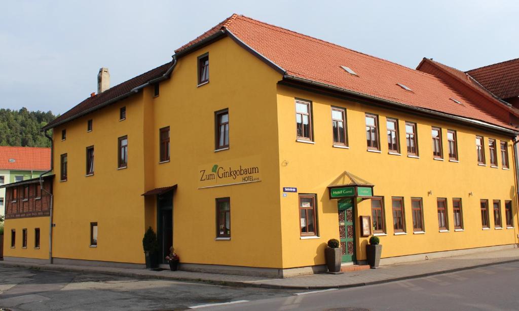 um edifício amarelo no lado de uma rua em Zum Ginkgobaum em Stadtilm
