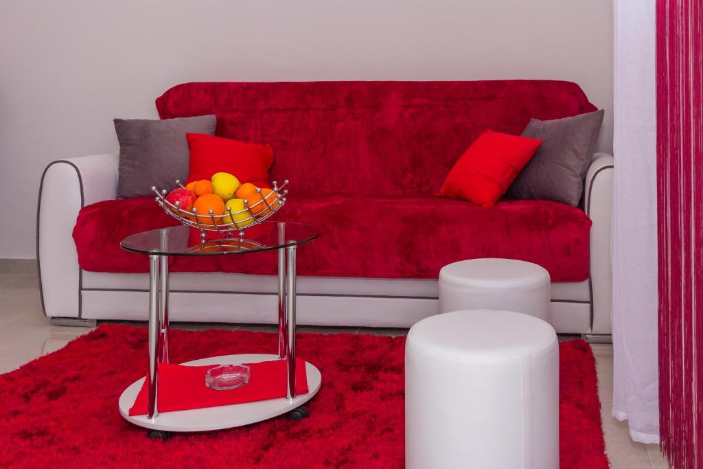 a living room with a couch and a bowl of fruit on a table at Apartment Ema in Split
