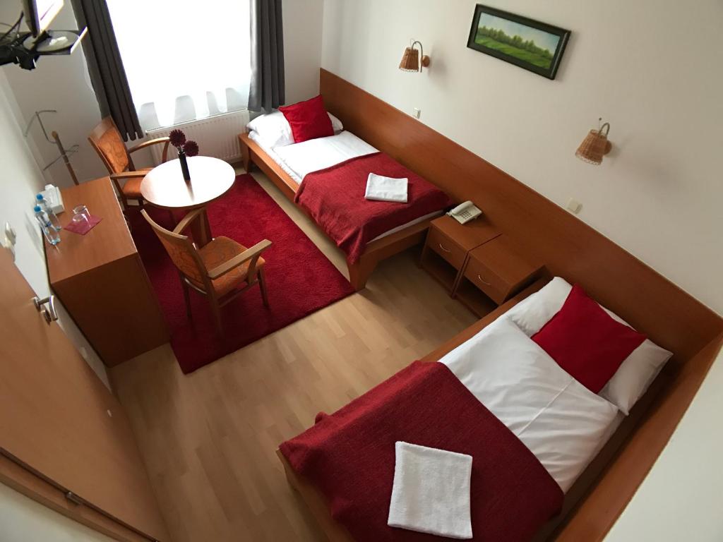 Postel nebo postele na pokoji v ubytování Hotel ROSE Břeclav