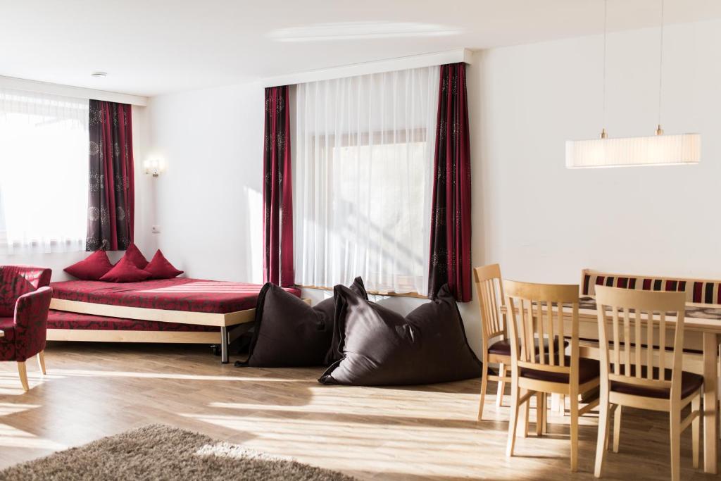 sala de estar con cama, mesa y sillas en Appartements Solaris, en Sölden