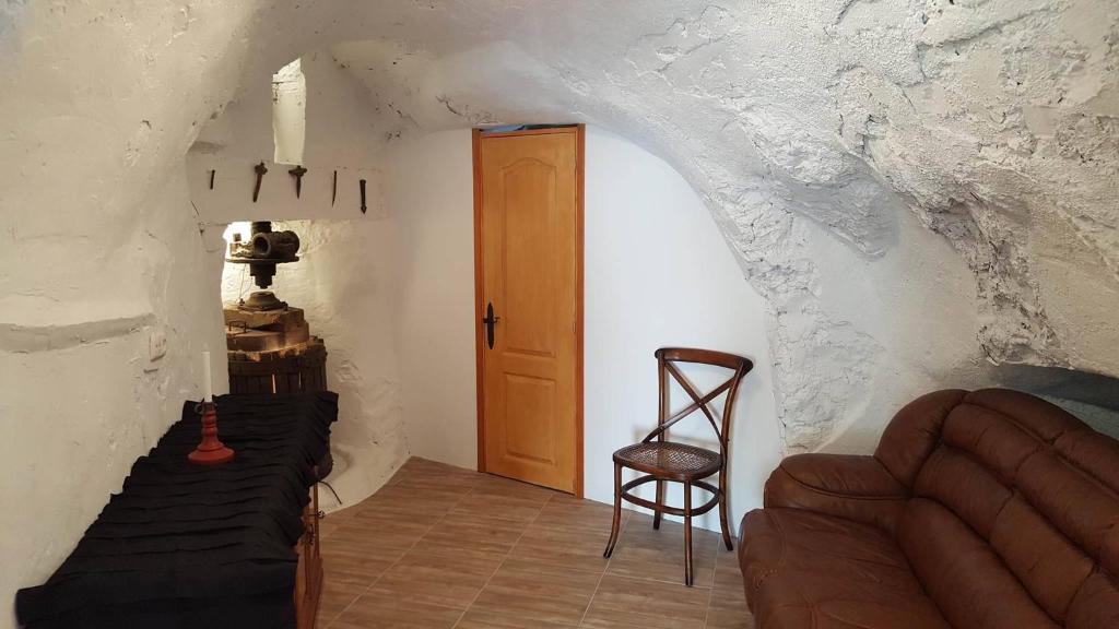 a hallway with a door and a chair in a room at Casa Bera in Arnedillo