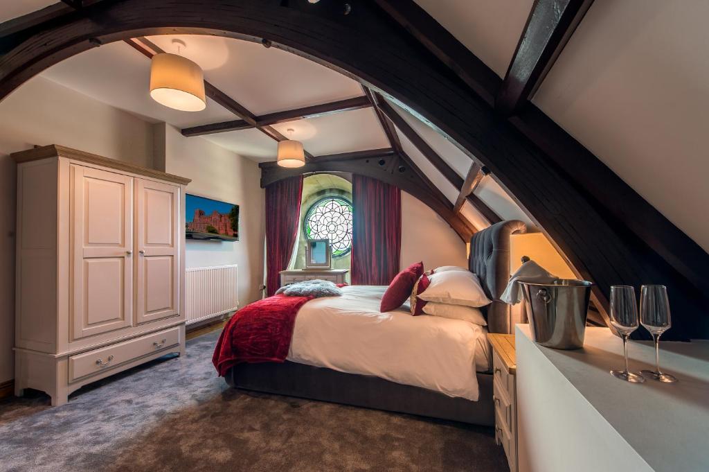 a large bedroom with an arched ceiling and a large bed at St Nicholas Boutique Hotel in Shrewsbury