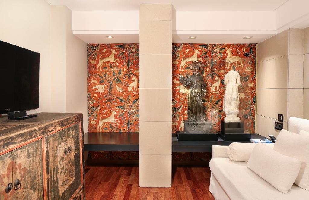 a living room with a large painting on the wall at Claris Hotel & Spa GL, a Small Luxury Hotel of the World in Barcelona