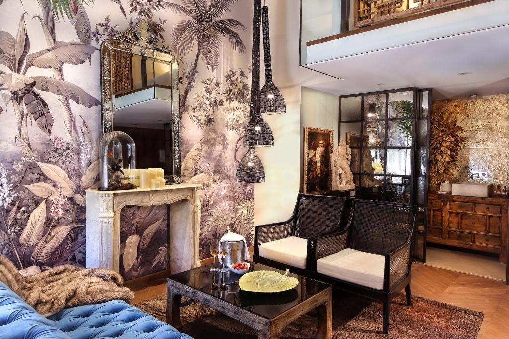 a living room with a couch and a chair at Claris Hotel & Spa GL, a Small Luxury Hotel of the World in Barcelona