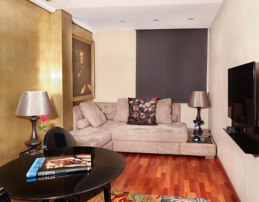 a living room with a couch and a table at Claris Hotel & Spa GL, a Small Luxury Hotel of the World in Barcelona