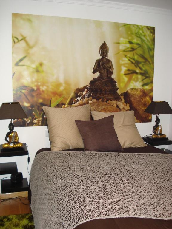 a bedroom with a bed with two lamps on tables at Stone House in Sabugueiro