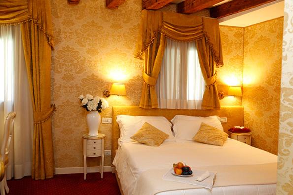 a bedroom with a bed with a tray of fruit on it at Casa dei Cavalieri in Venice