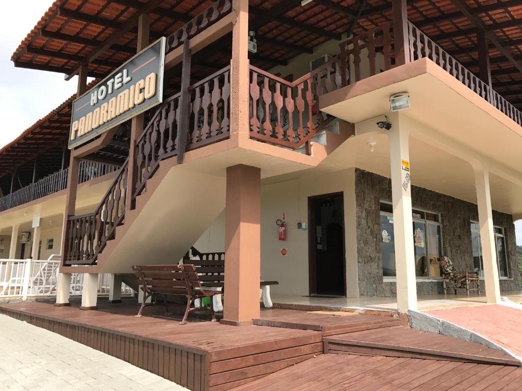 a building with a balcony and a bench on a deck at Hotel Panorâmico in Penha