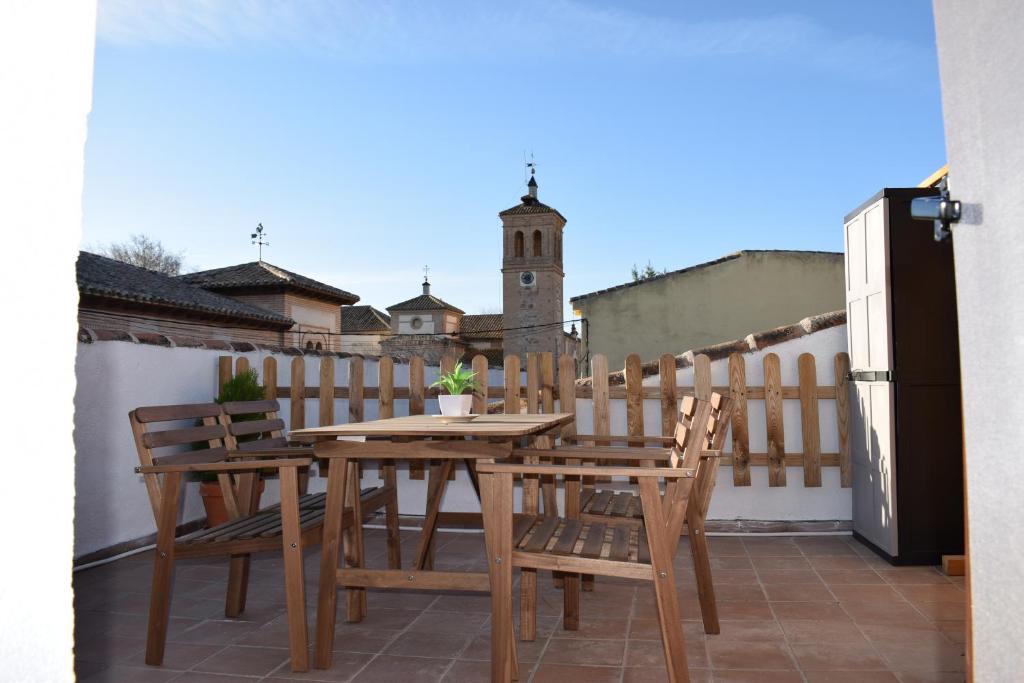 a wooden table and chairs on a balcony at Apartamento Mercedes in Cobisa