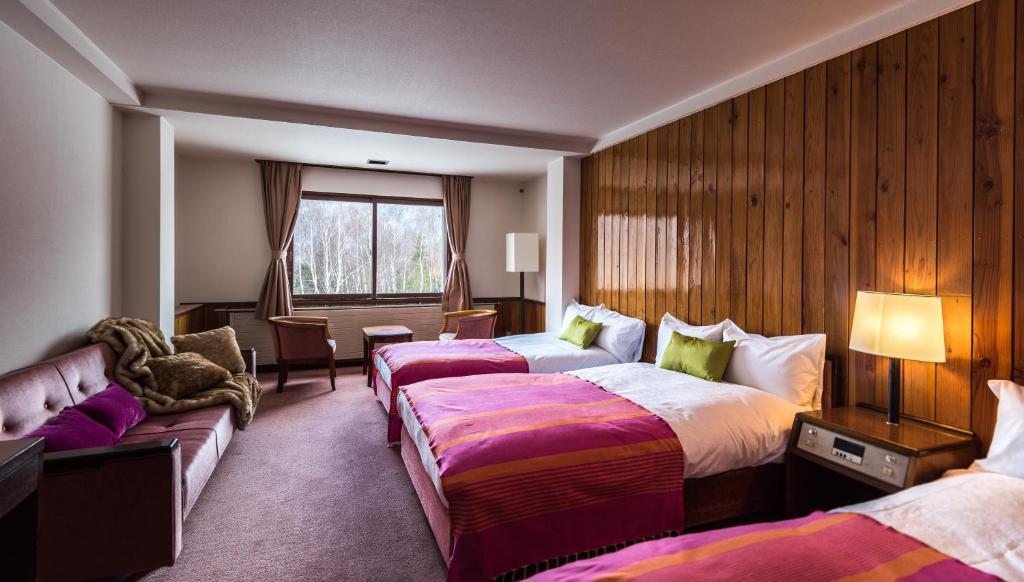 Postel nebo postele na pokoji v ubytování Okushiga Kogen Hotel