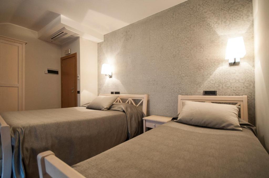 Postel nebo postele na pokoji v ubytování Hotel Maloia