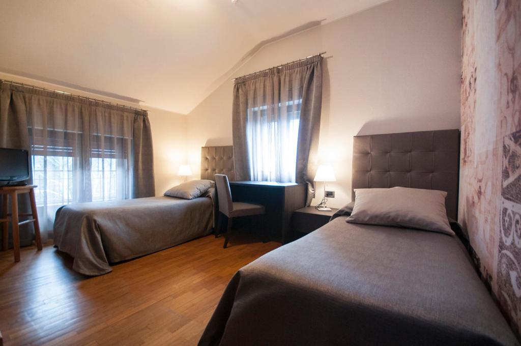 Postel nebo postele na pokoji v ubytování Hotel Maloia