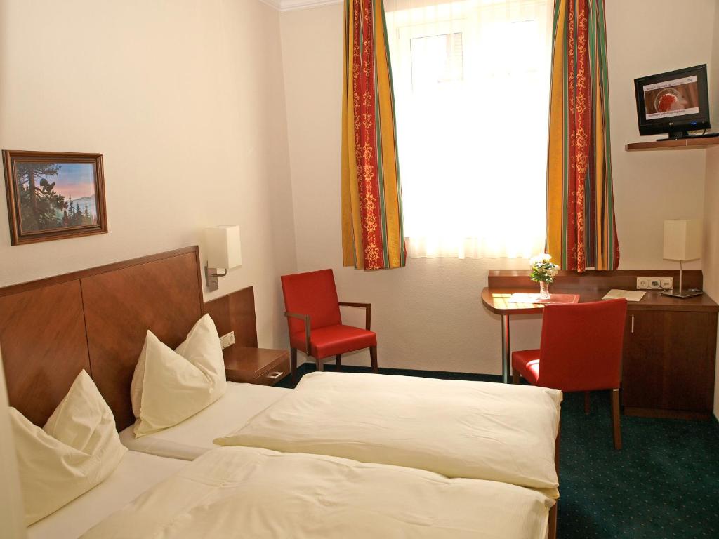 Postel nebo postele na pokoji v ubytování Hotel Krug