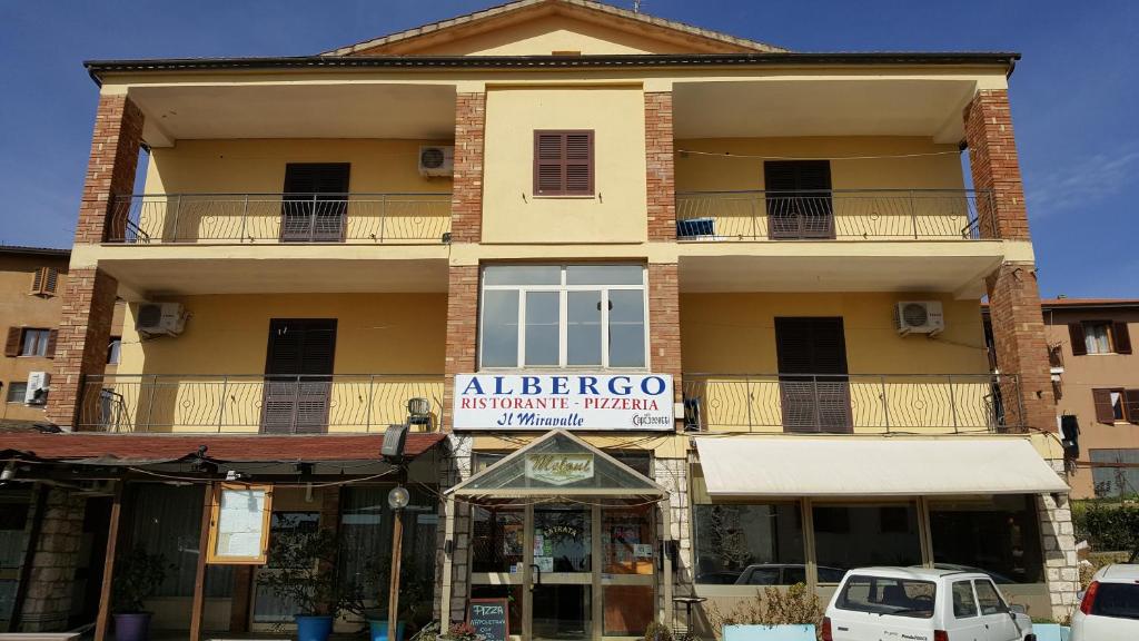 an apartment building with a sign that reads albergo architecture retrieval at Il Miravalle Ristorante & Camere in Manciano