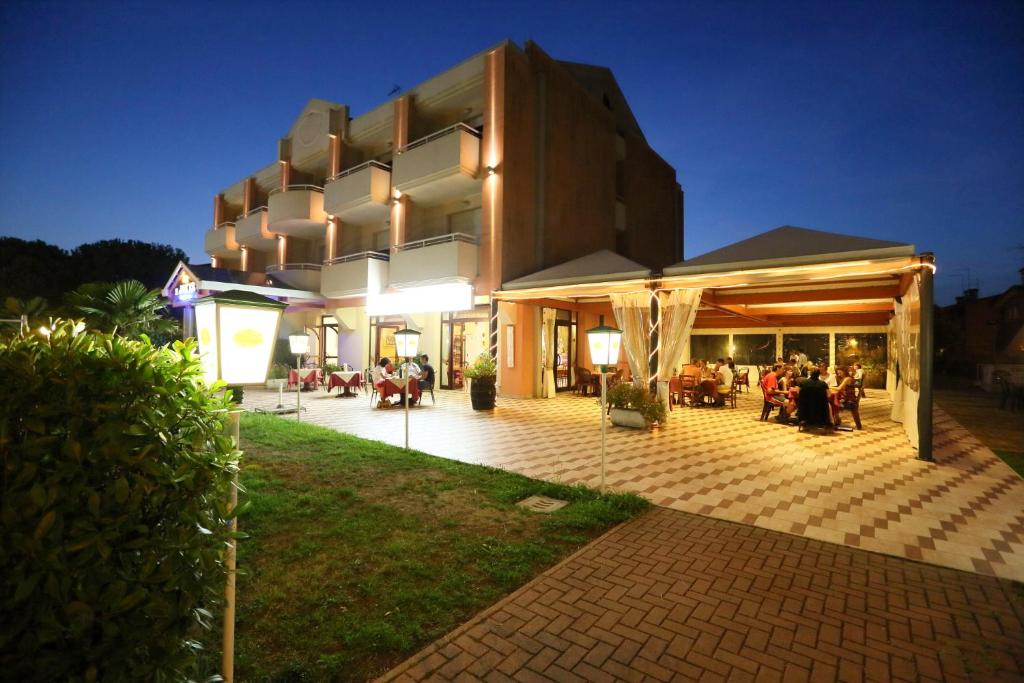 a large building with a patio at night at Residence Joker in Cavallino-Treporti