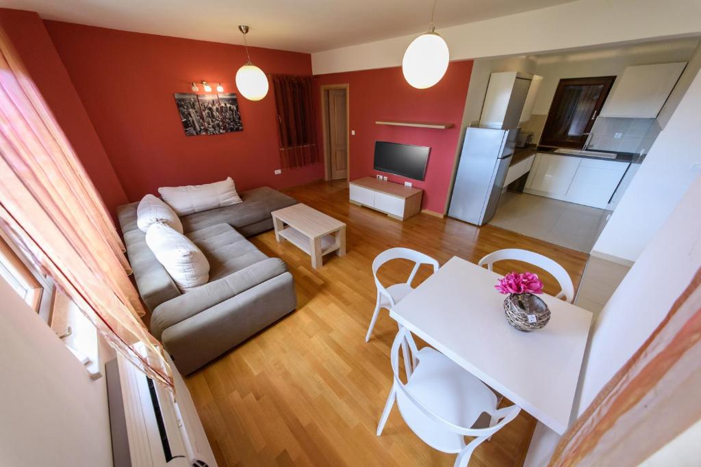 a living room with a couch and a table at Apartments Vacanza in Zadar