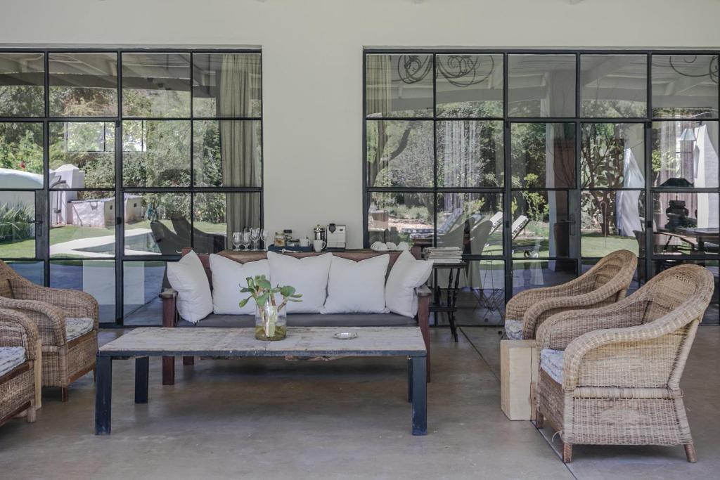 a living room with a couch and two chairs at The Whyte House in Graaff-Reinet